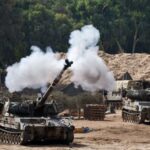 A mobile artillery unit fires towards Gaza near the border