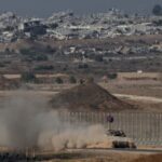 An Israeli APC manoeuvres on Israeli side of the Israel-Gaza