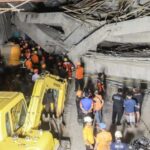 Search and rescue officers search for victims in the rubble
