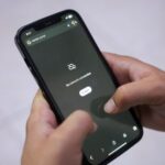 A man tries to use Google on his smartphone amid