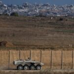 An Israeli armoured personnel carrier (APC) manoeuvres on Israeli side