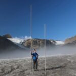Glaciologist Huss of ETH Zurich holds a pole marking the