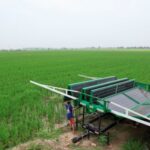 Worker installs a folding solar panel unit, to run a