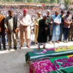 People attend the funeral of men, who were killed during