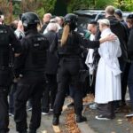 People gather near the scene following an incident outside a