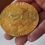 An employee of the Norwegian Nobel Institute holds a replica