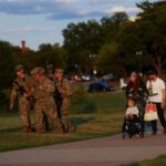 FILE PHOTO: Members of the National Guard carry firearms as