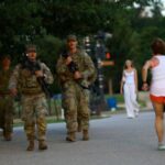 FILE PHOTO: Members of the National Guard carry firearms as