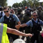 People protest during a standoff with ICE and federal officers