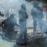 People protest during a standoff with ICE and federal officers