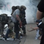 People protest during a standoff with ICE and federal officers