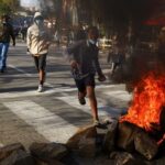 Protesters flee from police officers during a nationwide youth-led protest