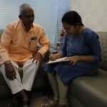 Laksmi Chandana and her father fill up a client on-boarding