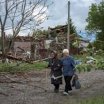 FILE PHOTO: Residents walk at a street near buildings in