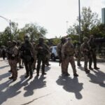FILE PHOTO: People protest during a standoff with ICE and