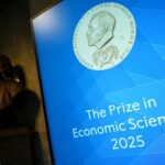 Screen displays an image of Nobel Prize medal, ahead of