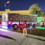 FILE PHOTO: Trucks carrying aid bound for Gaza cross the