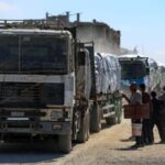 Trucks carry aid for Palestinians in Khan Younis
