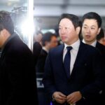 SK Group Chairman Chey Tae-won arrives to attend a hearing