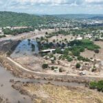 Drone view shows debris and damaged houses amid muddy floodwater