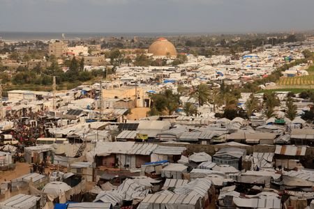 Displaced Palestinians shelter at a tent camp in Khan Younis