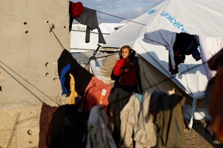 Displaced Palestinians shelter in a tent camp in Deir al-Balah