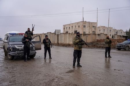 Syrian security forces outside al-Aqtan prison, where some Islamic State