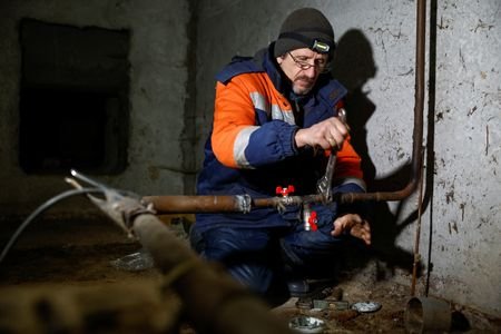 Ukrainian Railways employee Volodymyr Vasiliev works inside a basement of