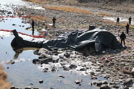South Korean military officials secure the site where an AH-1S