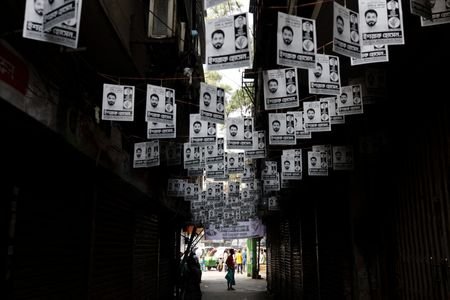 Election campaign posters hang over a street a day ahead