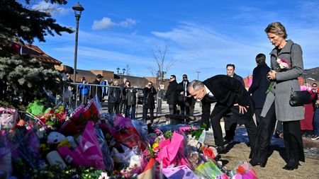 Canada's Prime Minister Mark Carney visits a makeshift memorial, after
