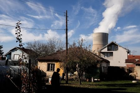 A man walks near the coal-fired power plant, in Obilic