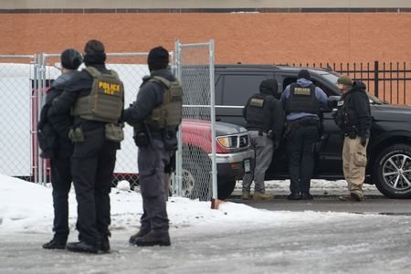 Members of U.S. Immigration and Customs Enforcement (ICE) conduct raids