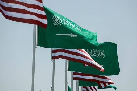 U.S. and Saudi flags flutter along a highway of Riyadh