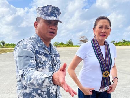 Philippine Coast Guard spokesperson Commodore Jay Tarriela gestures beside Philippine