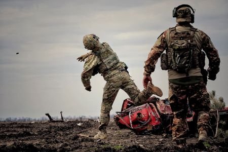 FILE PHOTO: Ukrainian serviceman throws a grenade during a training