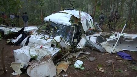 Police and security personnel work at the site where the