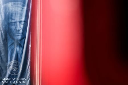 A banner depicting U.S. President Donald Trump hangs outside the