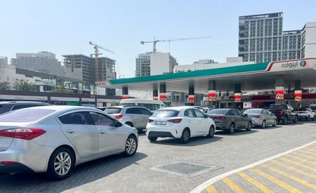 Cars queue outside a petrol station, after an Iranian attack,