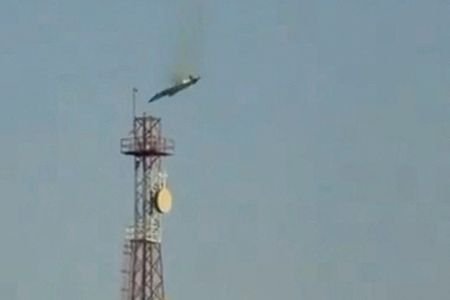 A burning aircraft falls from the sky in Al Jahra,