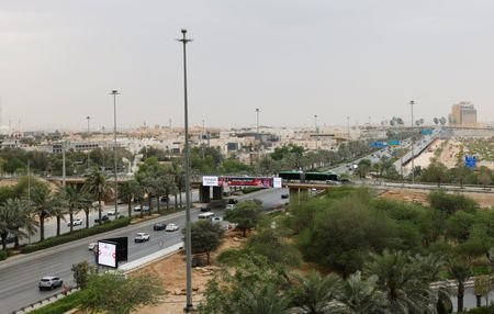 Vehicles ply along a road, amid the U.S.-Israeli conflict with