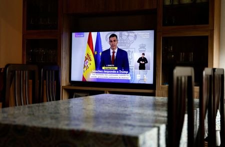 TV screen shows live broadcast of Spain's Prime Minister Pedro
