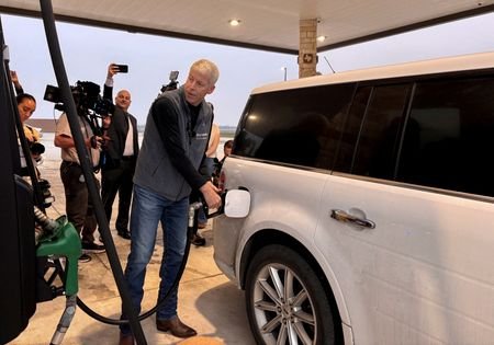 FILE PHOTO: U.S. Energy Secretary Chris Wright pumps gas and
