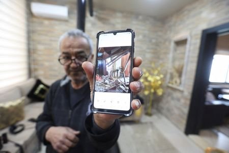Hussain Khrais shows a picture on his phone of his