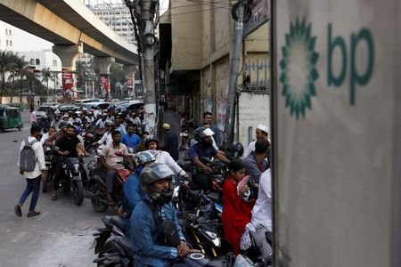 FILE PHOTO: Vehicles queue at a fuel station, as concerns
