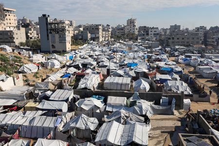 Palestinians displaced during the two-year Israeli offensive, shelter at a