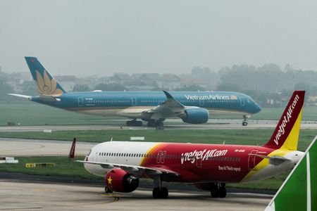 FILE PHOTO: An airplane of VietJet airline and Vietnam Airlines