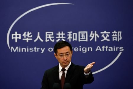 Chinese Foreign Ministry spokesperson Lin Jian gestures during a press