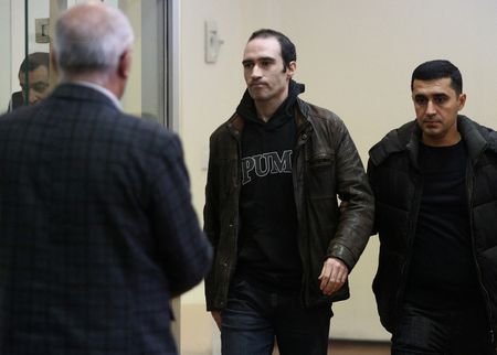 French national Martin Ryan, accused of espionage, attends a court