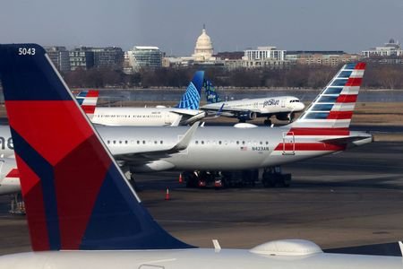 FILE PHOTO: A JetBlue aircraft lands under the DC skyline